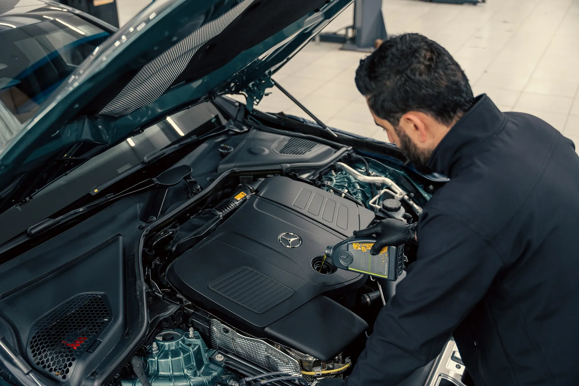 Mechanic inspecting the engine bay of a car