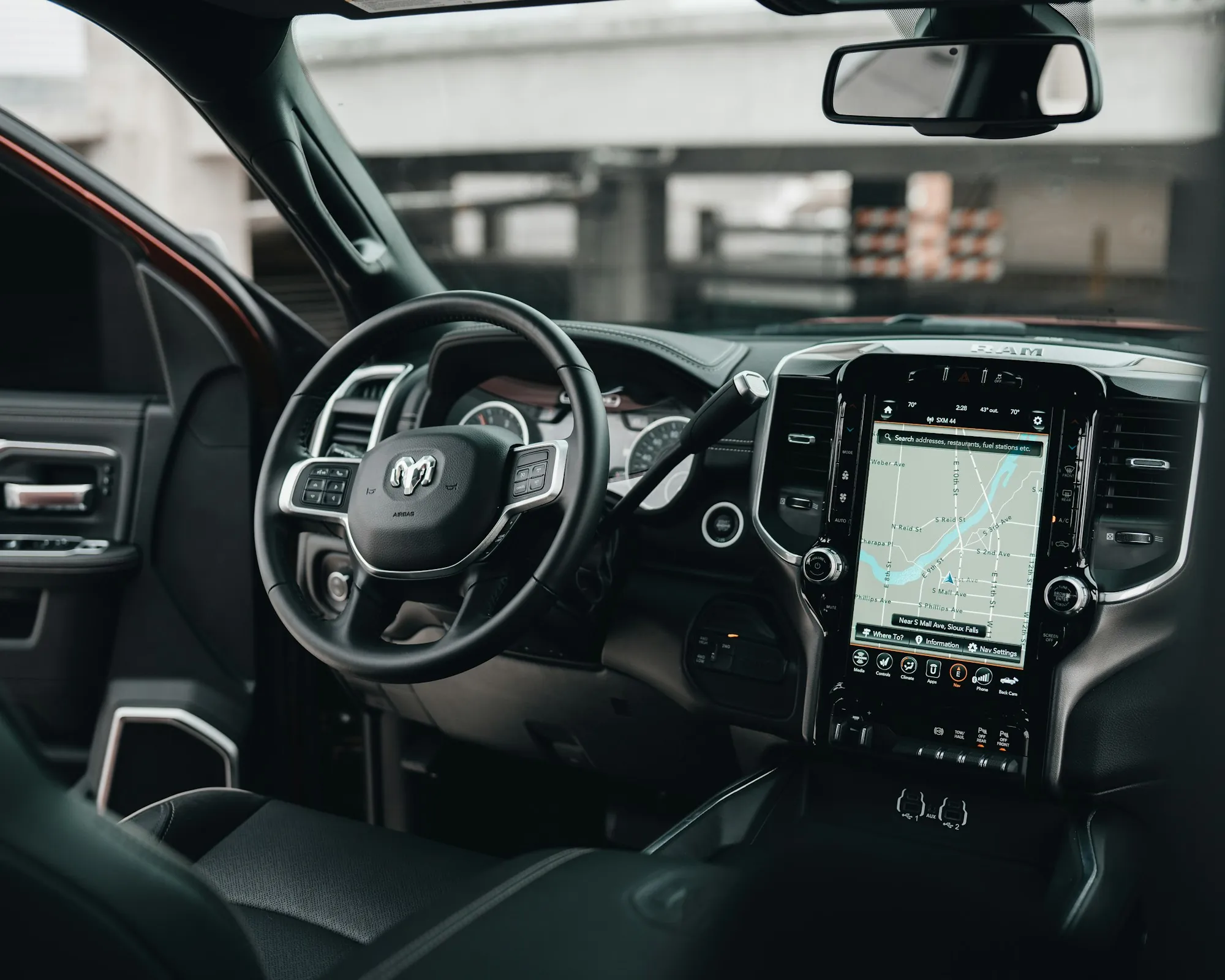 View from the driver's seat of a modern car dashboard with a display screen