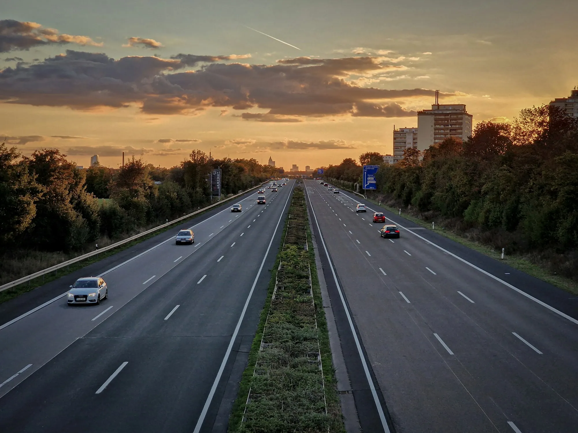 Highway lanes at sunset with light traffic