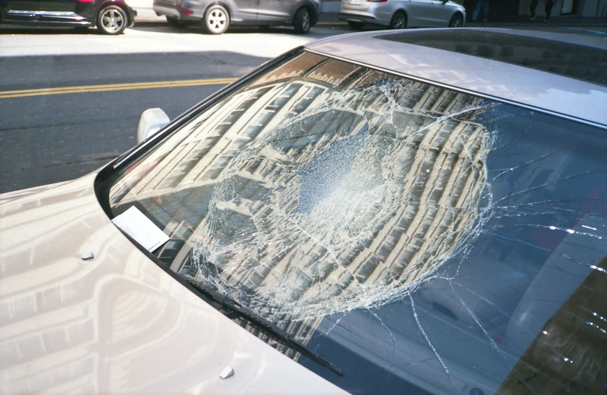 Cracked windshield on a car parked outdoors