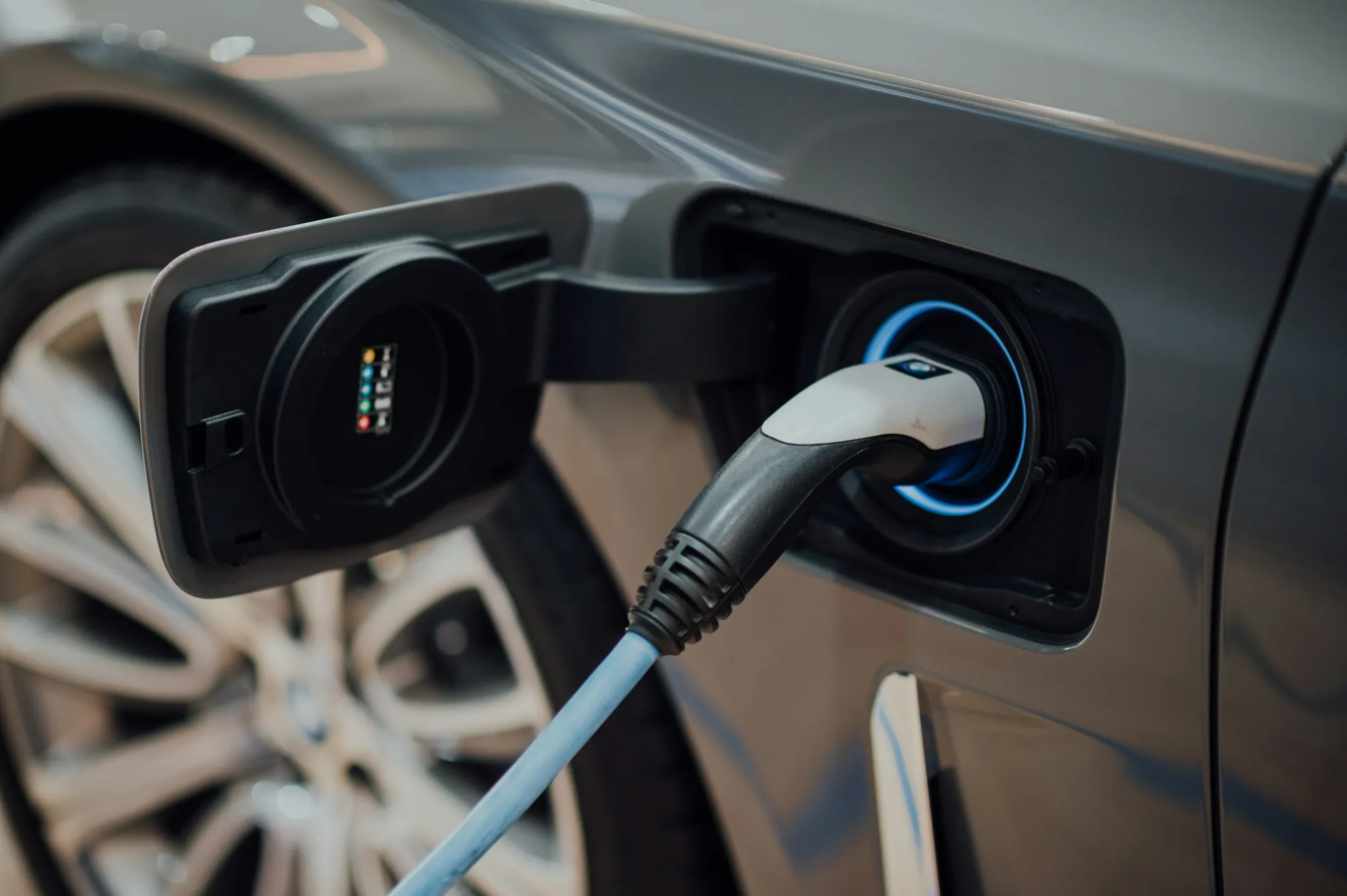 Charging cable plugged into the port of an electric vehicle