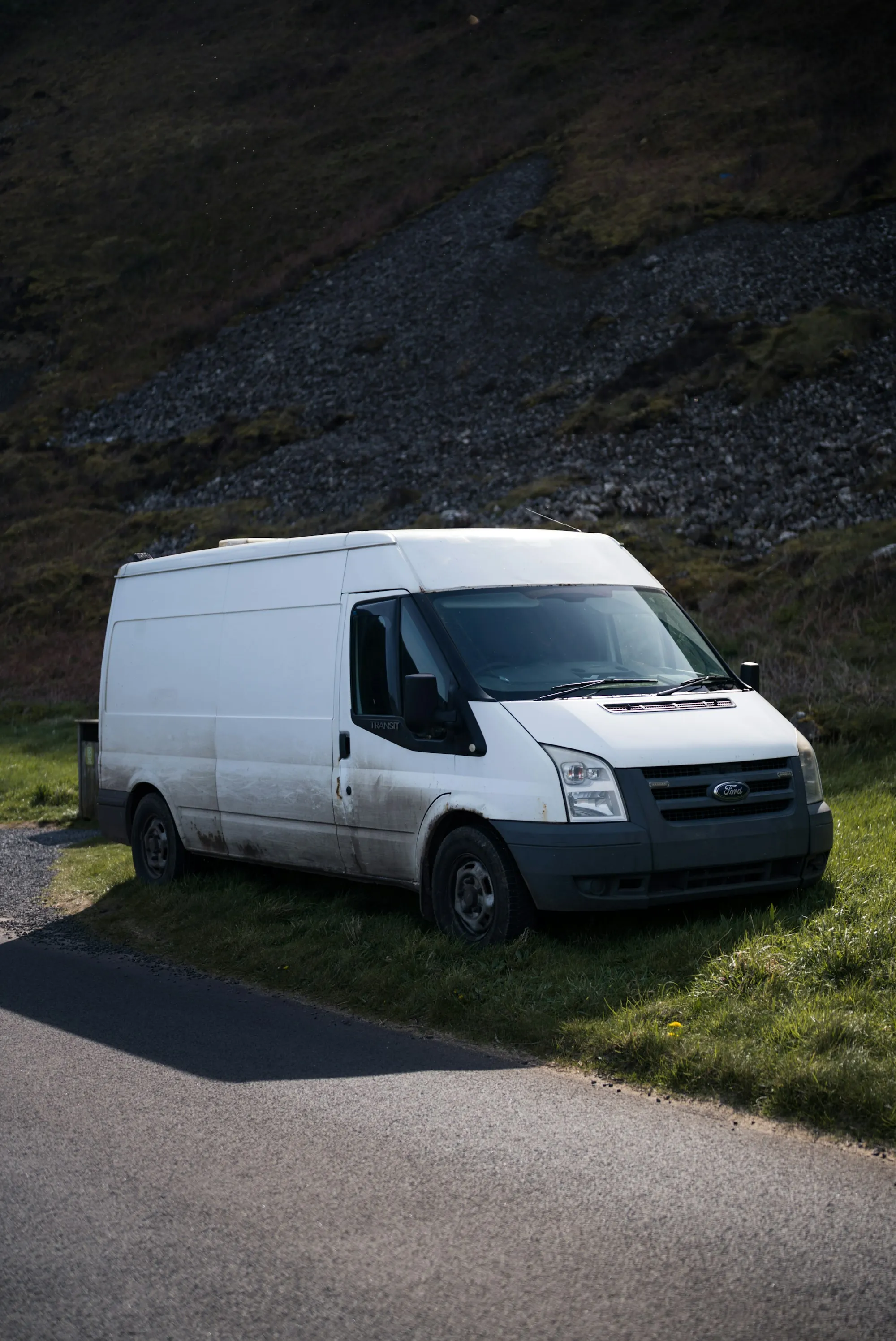 White work van parked on gravel