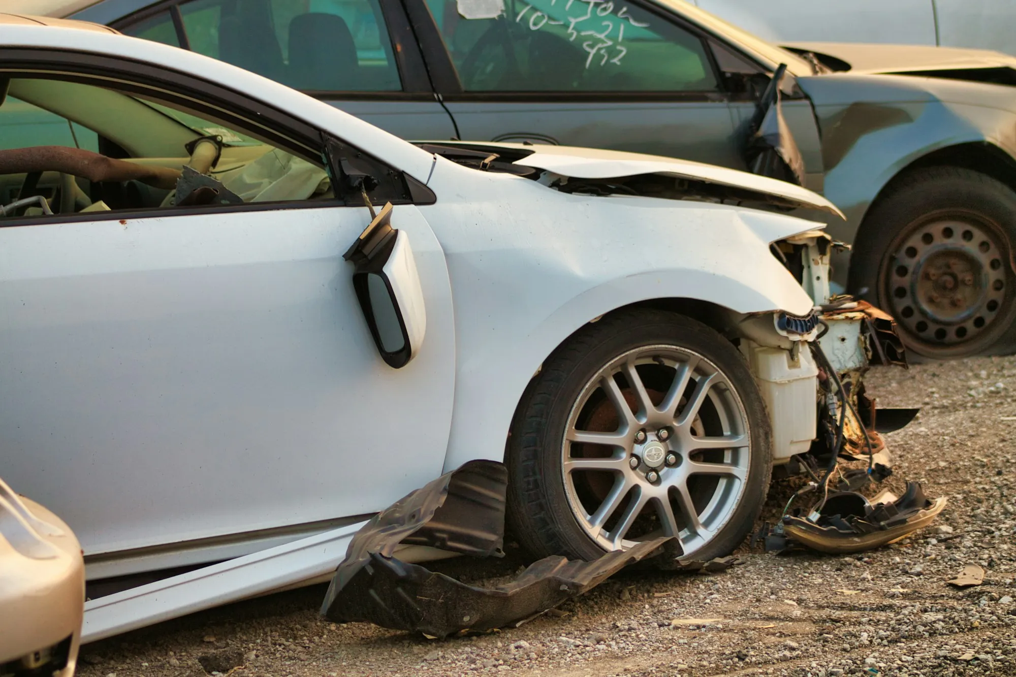 White car with front damage after a collision